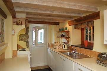 The small but well-equipped kitchen leads out to the patio garden.
