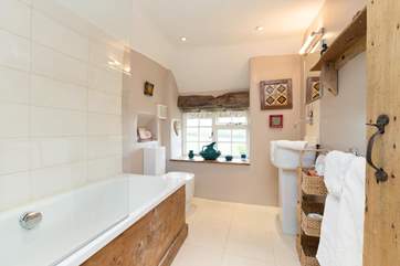The bathroom looks out over the patio and side garden - glimpses of the countryside whilst lazing in the bath!