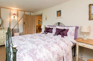 This beautiful double bedroom has an antique bed and luxurious bed linens.