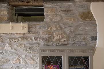 A tiny window up in the hall wall gives more light to the kitchen/diner.