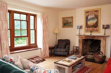 The sitting-room has an open fire and deep window seats.