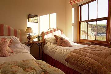 The twin bedroom overlooks the valley towards the sea.