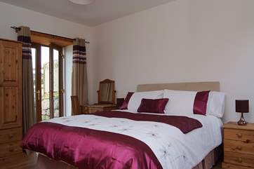 Bedroom 2 has a king-size double bed and an en suite shower-room.