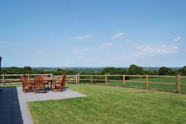 Enjoy al fresco dining in the garden - the post and rail fence has been faced with netting to provide security for children.