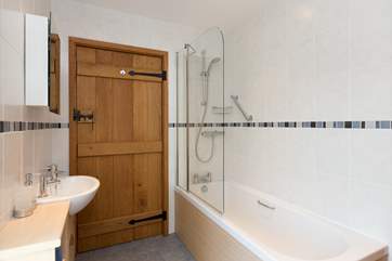 The en suite for the master bedroom has a bath and a fitted shower. There is also a door to the living room giving extra flexibility for a family.