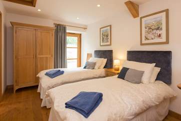 At the other end of the cottage is the twin bedroom. This also has French windows out to the garden.