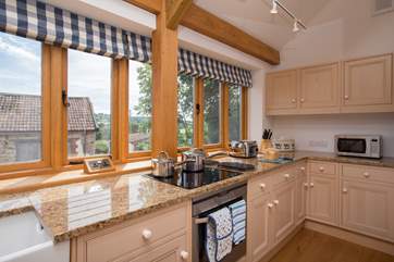 Cooking up a treat in this extremely well-equipped kitchen with a view across the back of the original farmstead is a treat too.