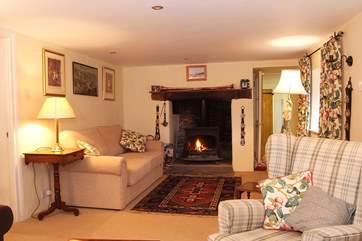 The utility-room and downstairs shower-room are through the door at the far end of the sitting-room.