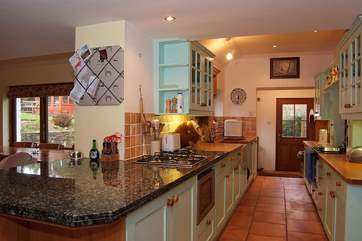 The entrance to the cottage leads up into the lovely country-style kitchen.