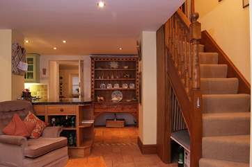 Stairs lead from the open plan living-area to the bedrooms and bathroom on the first floor.