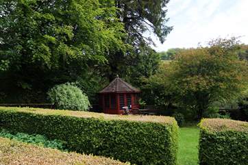 There is a pretty raised garden with a summer-house and seating-area.