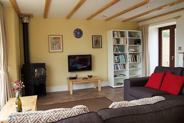The cosy sitting-area with wood-burner, great television and books!
