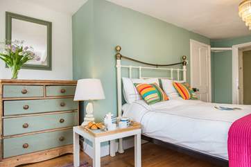 Bedroom 1 has an attractive bedstead.