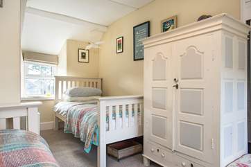 The twin bedroom is light and airy and has plenty of storage