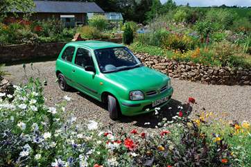 Your private parking space is surrounded by flower beds.