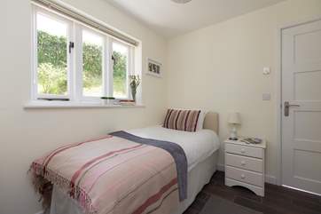 The pretty single bedroom is at the back of the studio with its own access through this door - leading to the cloakroom - as well as to the wet-room.