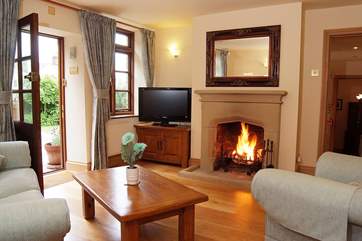 The sitting-room has solid wood floors and a traditional stone fireplace.