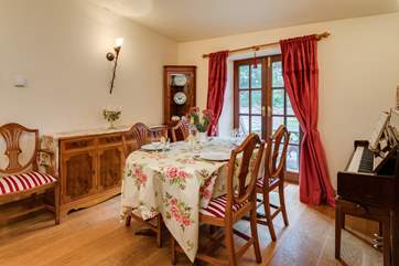 There is a separate dining room and even a piano. A second set of French windows lead out to the terrace.