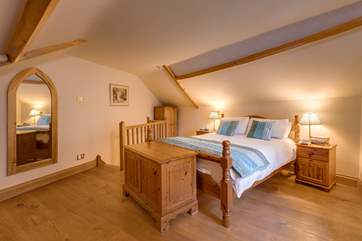 This is the large master bedroom on the first floor. Take care of the lower edges of the sloping ceiling