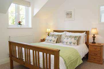 The double bedroom is prettily furnished.