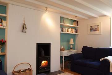 The comfortable sitting-room has a roaring wood-burner.
