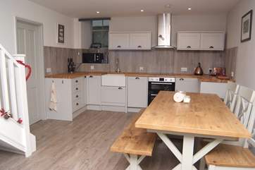 The kitchen dining-area, where stairs (to the left) go up to the bedrooms.