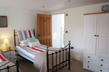A small step leads up from the twin bedroom into the en suite wet-room.