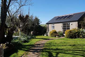 The Little Cabin is set at the end of a pretty garden.
