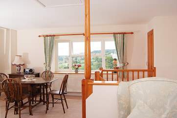 Looking from the sitting-room across to the dining-area with its own spectacular view down the valley to the village.
