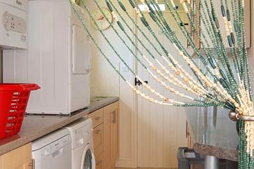 The utility-room is downstairs, at the far end of the spacious hallway.