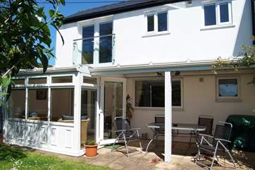 The sheltered, private patio is ideal for enjoying an evening barbecue.