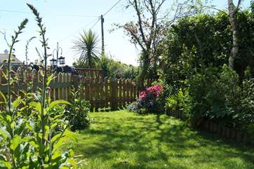 The pretty little garden is full of colour in summer.