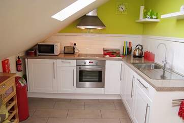 The compact but well-equipped kitchen area has a sloping ceiling - so please mind your head if you're tall!