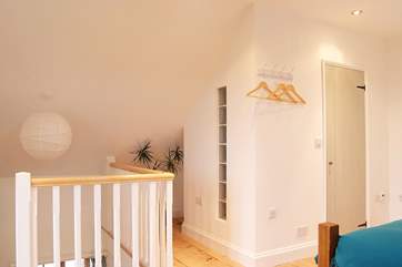 Stairs lead up to the galleried bedroom with the shower-room on the right-hand side.