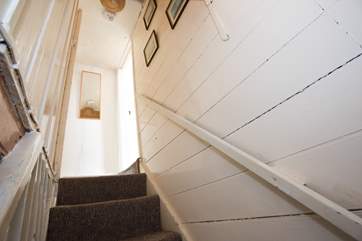 Steep cottage stairs lead up to the bathroom and the bedrooms.
