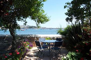 The sheltered, sunny waterfront garden with views of the estuary is across the lane from the cottage