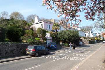 You can park briefly where the black car is in the photograph to unload. Please do not block the slope.
