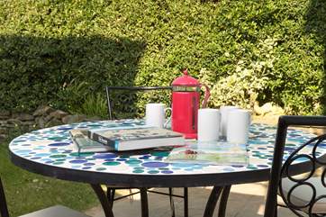 You can sit out on the patio at the front of the house looking out towards the beach across the enclosed garden.