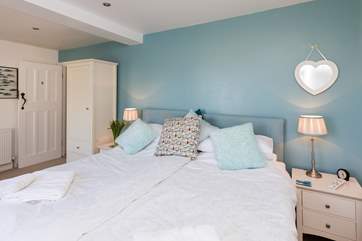 The master bedroom is at the sea-face of the house, with dual-aspect sash windows looking right out to sea.