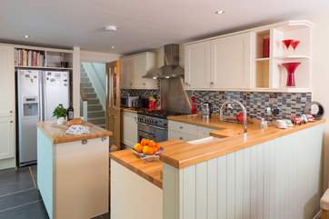 The kitchen is separated from the dining-area with its clever and functional design.