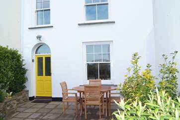 There are a table and chairs on the patio at the front of the property for eating outside