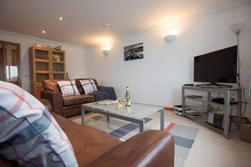 Leather sofas and a big TV for family films and essential sports games!