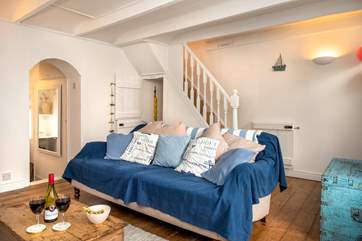 The sitting-room on the ground floor opens up to the rest of the cottage.
