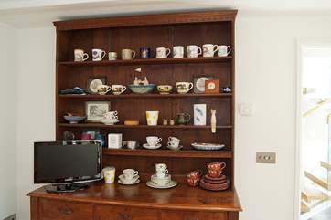 The old oak dresser houses a collection of vintage crockery.