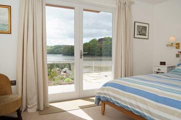 Bedroom 1 has French doors out to the waterside terrace.