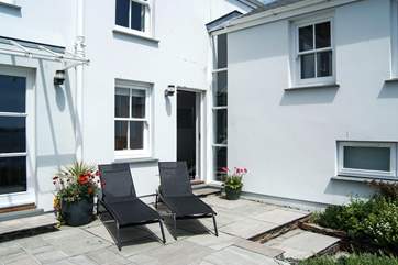 Sun loungers on the top level of the terraced garden.