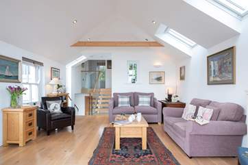 The sitting-room has windows on all sides making it wonderfully light and airy.