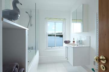 The family bathroom has a bath and shower.
