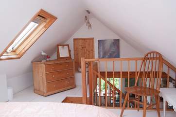 The bedroom is furnished with antique pine.
