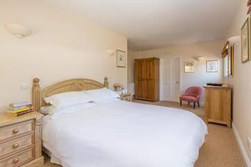 The master bedroom has plenty of space and a luxurious king-size bed.